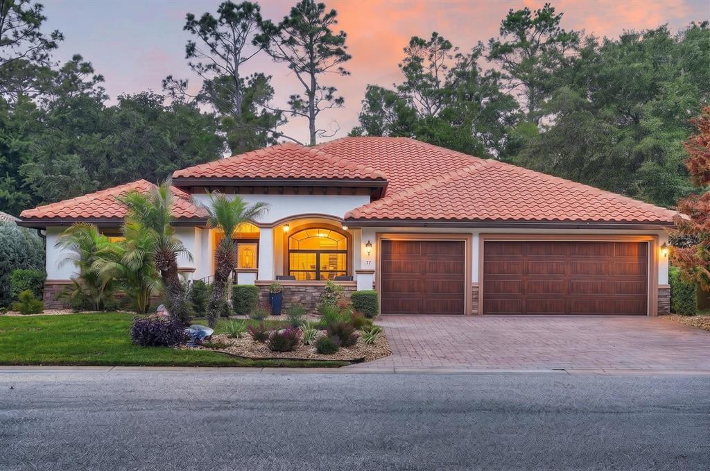 77 Apian Way Ormond Beach, FL 32174 - Photo 33 of 35 a front view of a house with a yard and garage