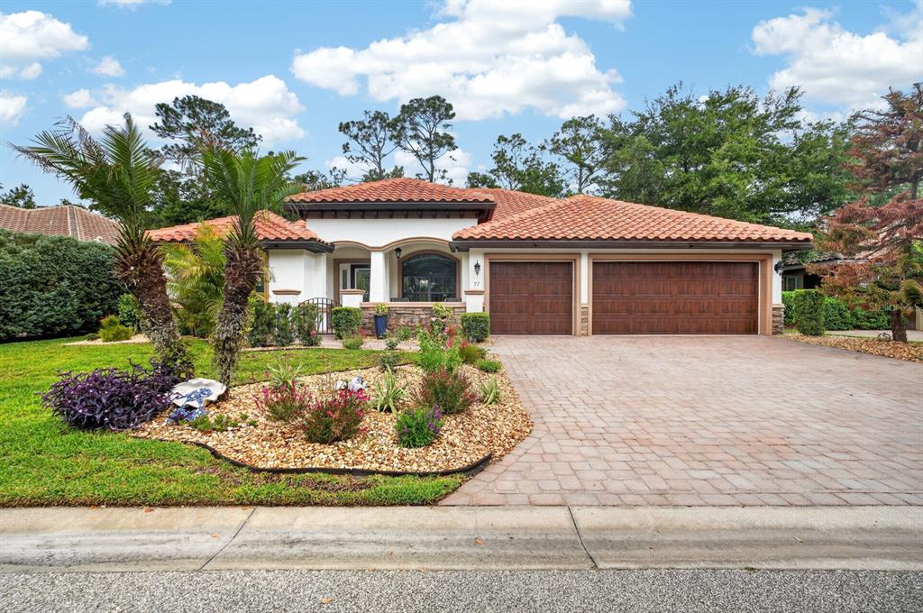 77 Apian Way Ormond Beach, FL 32174 - Photo 35 of 35 a front view of a house with a garden