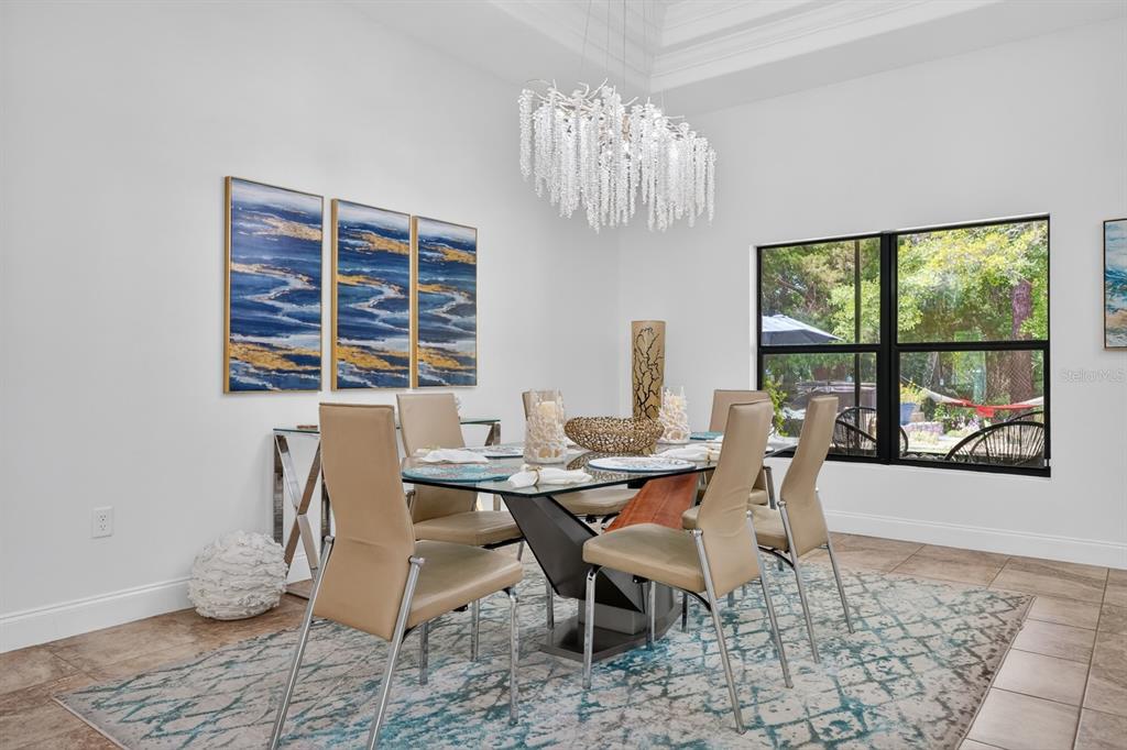 77 Apian Way Ormond Beach, FL 32174 - Photo 6 of 35 a view of a dining room with furniture a chandelier and wooden floor