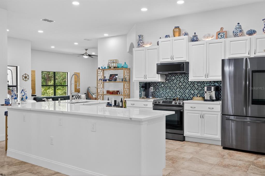 77 Apian Way Ormond Beach, FL 32174 - Photo 7 of 35 a kitchen with stainless steel appliances a refrigerator sink and cabinets