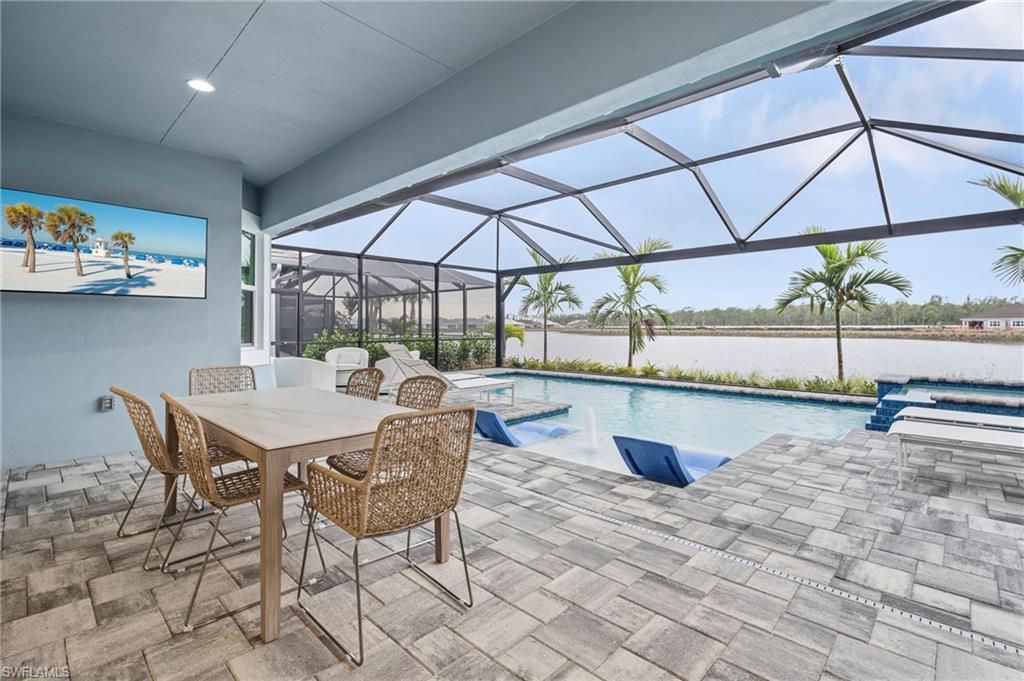 8795 Calypso Court Naples, FL 34113 - Photo 28 of 49 a dining room with furniture and a table