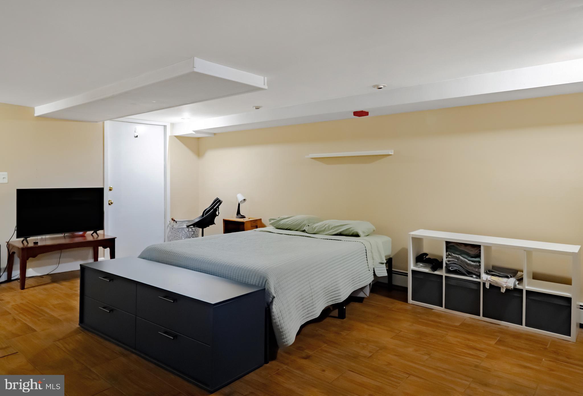 265 South 9th Street, Unit 1F Philadelphia, PA 19107 - Photo 13 of 15 a bed room with bed and a flat screen tv