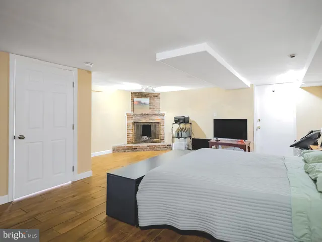 a bedroom with a bed and flat screen tv