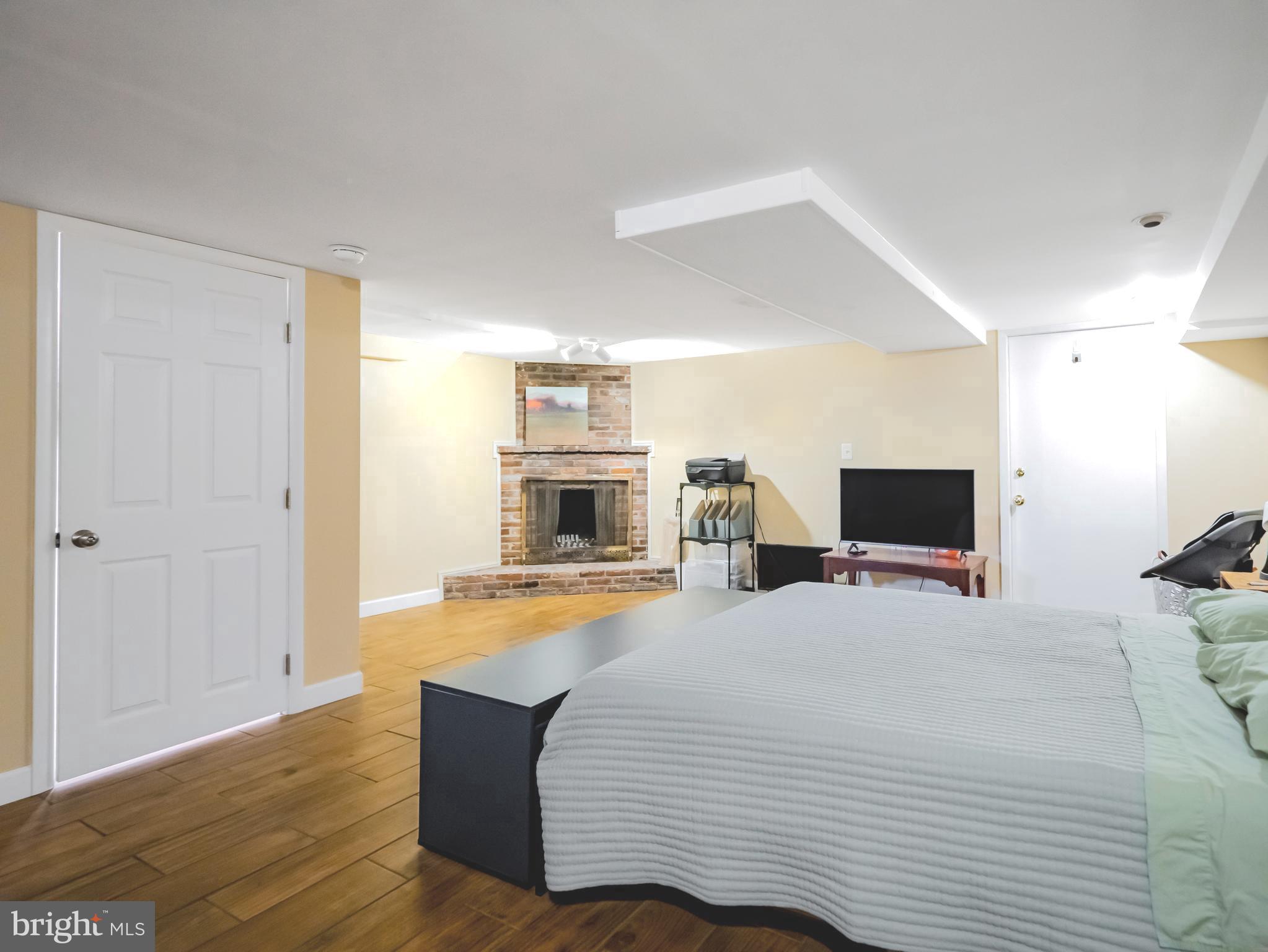 265 South 9th Street, Unit 1F Philadelphia, PA 19107 - Photo 2 of 15 a bedroom with a bed and flat screen tv