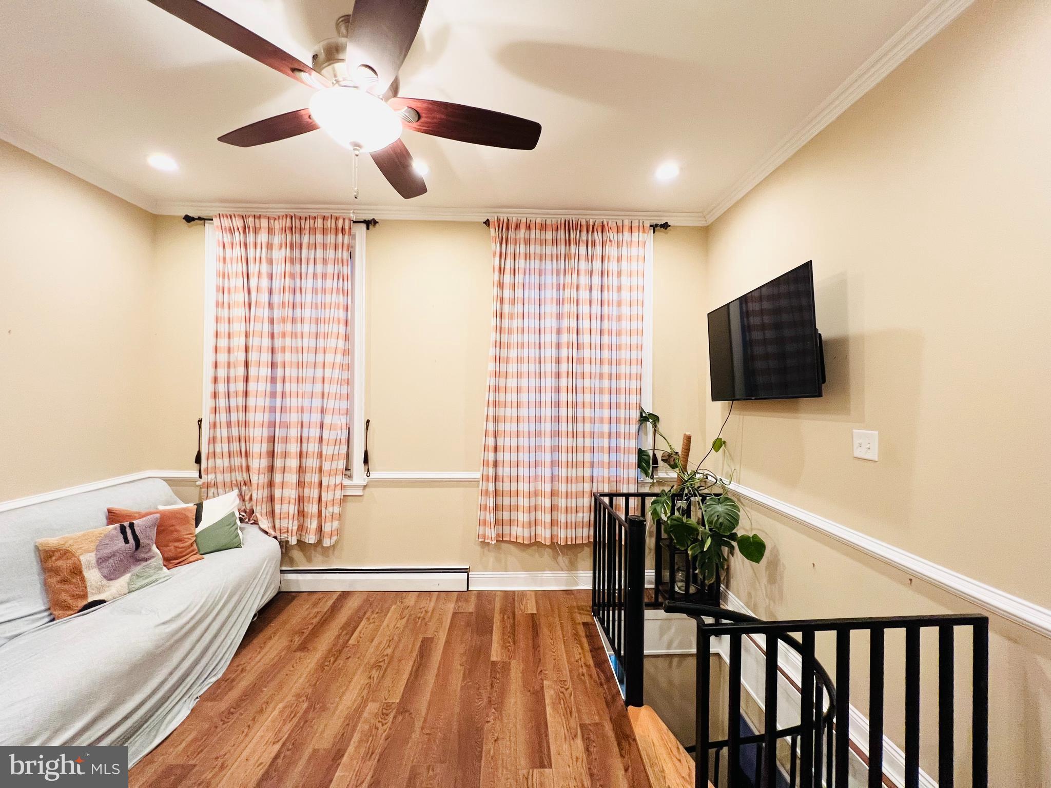 265 South 9th Street, Unit 1F Philadelphia, PA 19107 - Photo 4 of 15 a living room with furniture and a flat screen tv