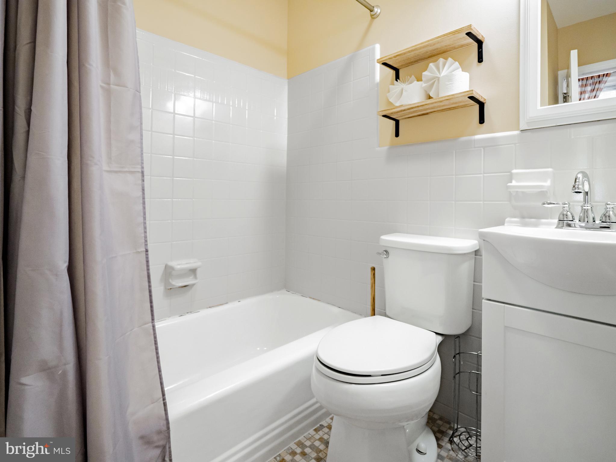 265 South 9th Street, Unit 1F Philadelphia, PA 19107 - Photo 8 of 15 a bathroom with a toilet sink and mirror
