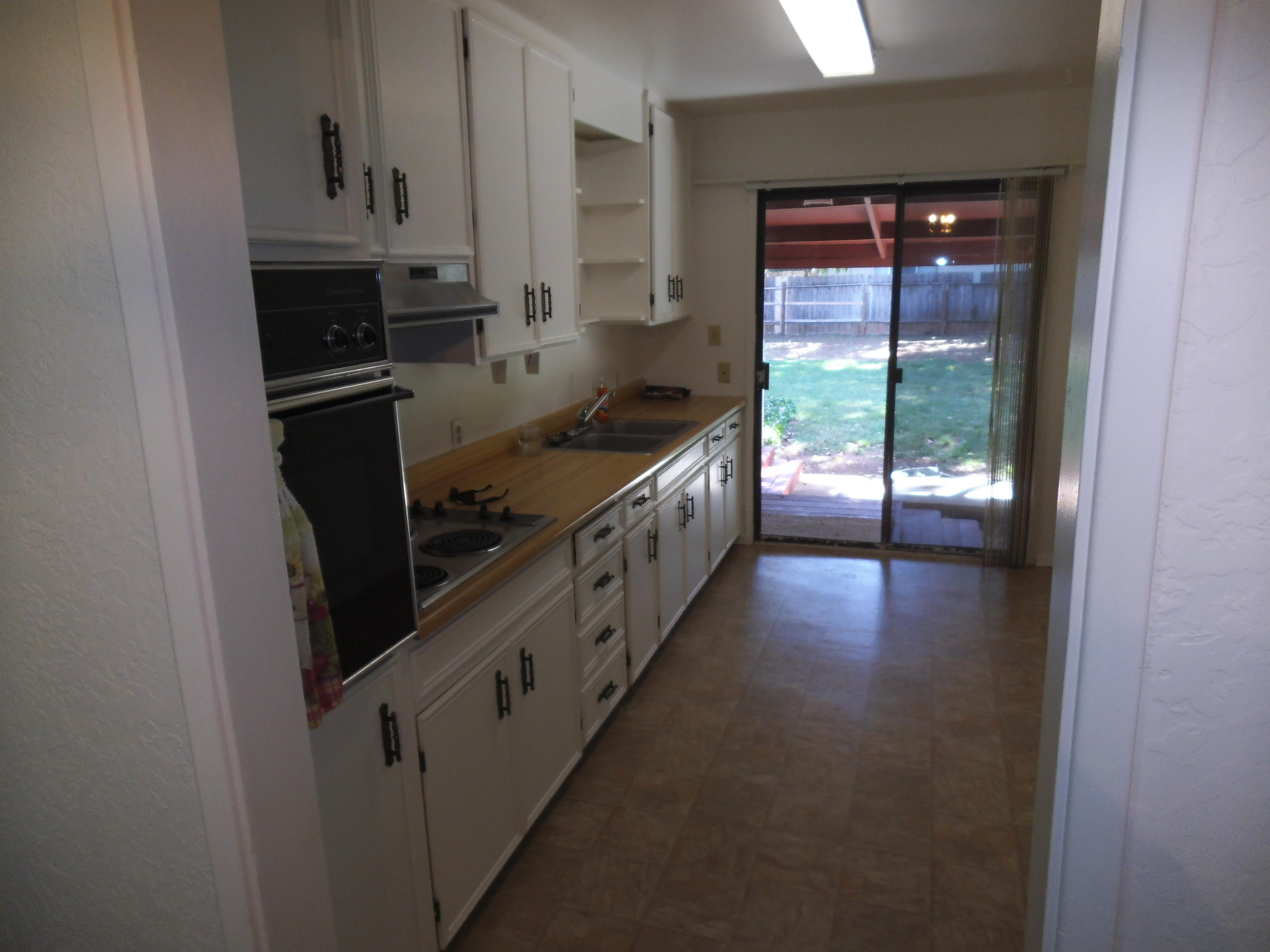 3607 Ricardo Avenue Redding, CA 96002 - Photo 4 of 20 a kitchen with granite countertop a refrigerator and a sink