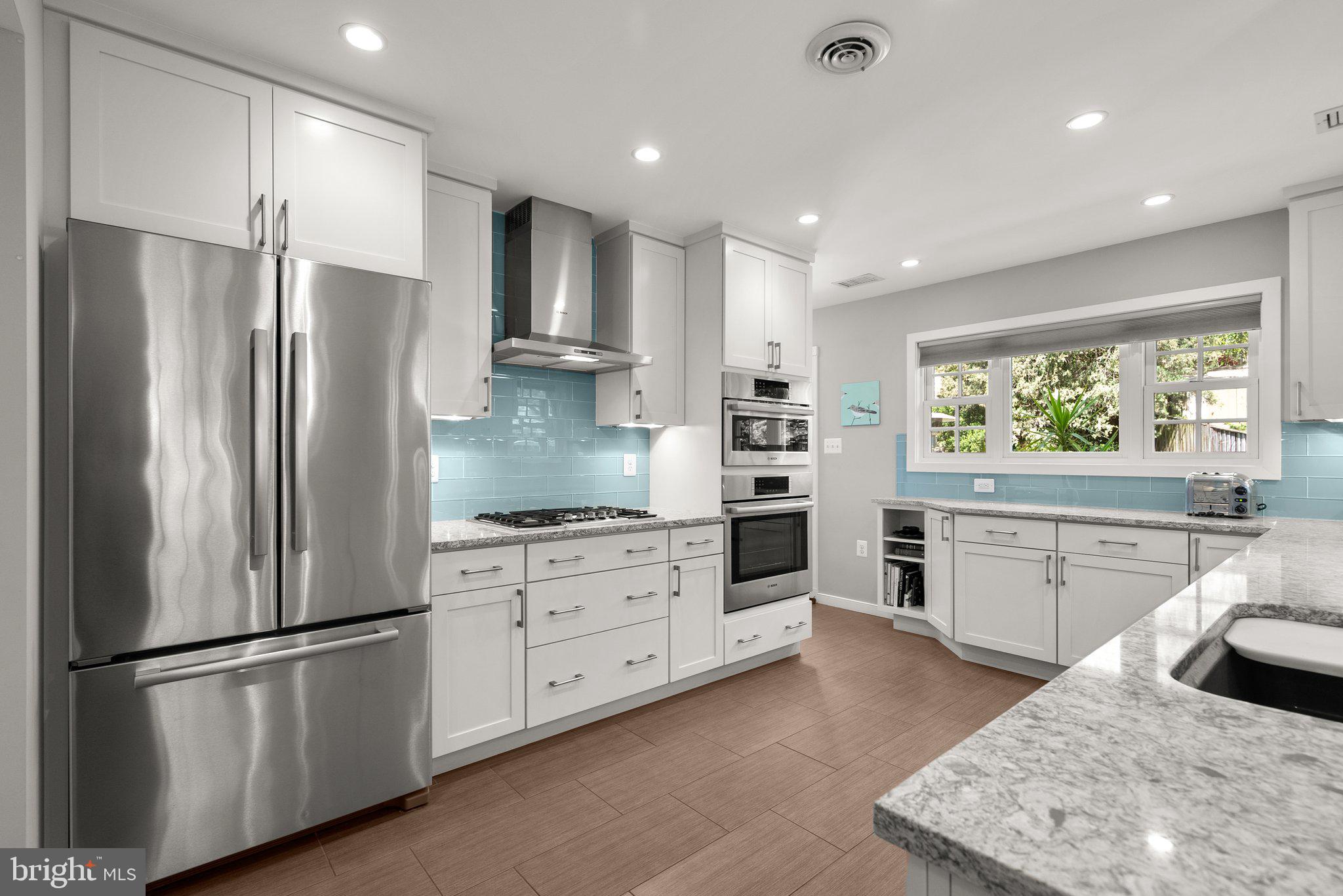 507 Ellsworth Drive Silver Spring, MD 20910 - Photo 11 of 42 a kitchen with stainless steel appliances granite countertop a refrigerator sink and stove