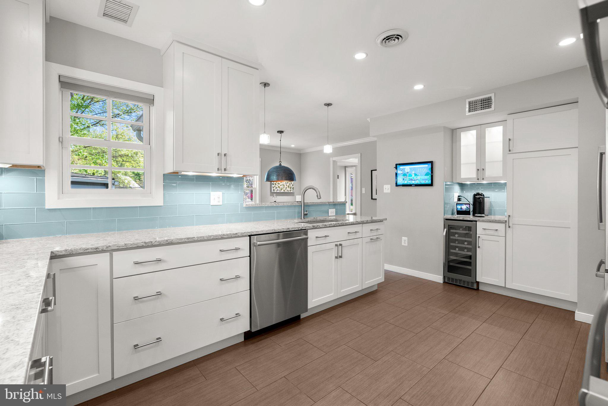 507 Ellsworth Drive Silver Spring, MD 20910 - Photo 13 of 42 a kitchen with white cabinets and white appliances