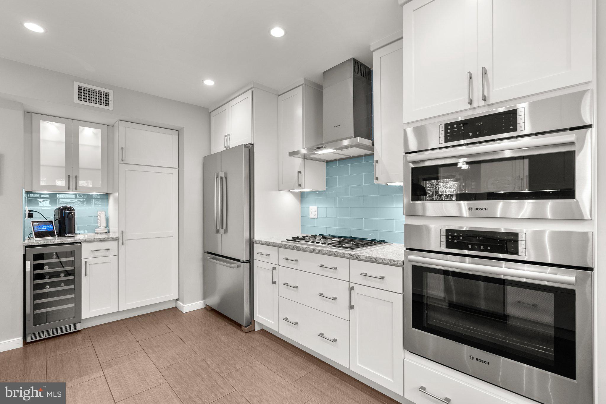 507 Ellsworth Drive Silver Spring, MD 20910 - Photo 14 of 42 a kitchen with stainless steel appliances white cabinets and wooden floor