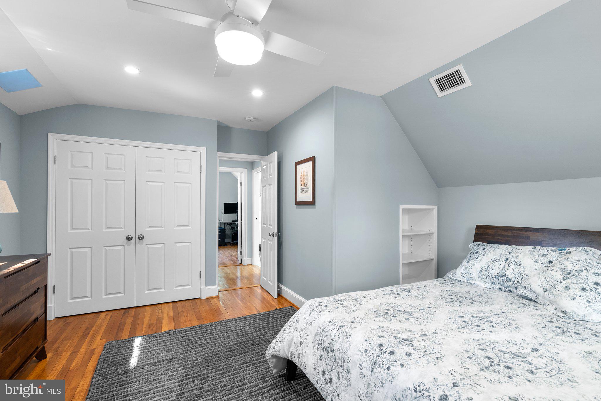 507 Ellsworth Drive Silver Spring, MD 20910 - Photo 29 of 42 a bedroom with a bed and wooden floor