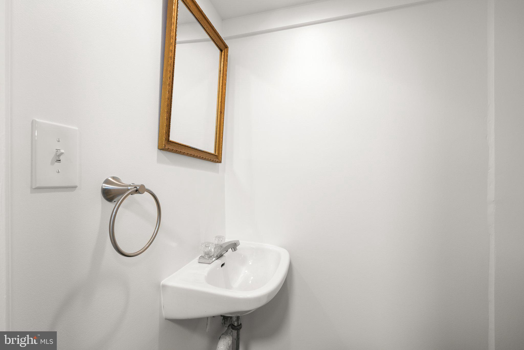 507 Ellsworth Drive Silver Spring, MD 20910 - Photo 35 of 42 a bathroom with a sink and a mirror