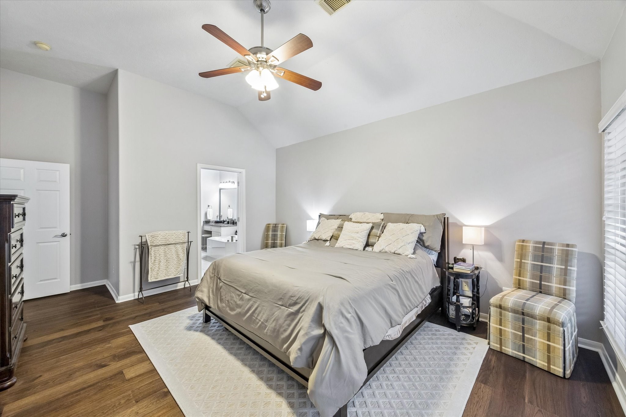 12423 Rutgers Park Court Houston, TX 77058 - Photo 25 of 29 a bedroom with a large bed chandelier and a window