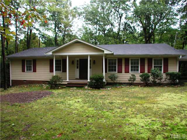 8416 Azalea Place Raleigh, NC 27613 - Photo 1 of 12 a front view of a house with a garden