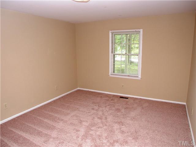 8416 Azalea Place Raleigh, NC 27613 - Photo 12 of 12 an empty room with a window