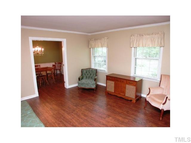 8416 Azalea Place Raleigh, NC 27613 - Photo 4 of 12 a living room with furniture and a wooden floor
