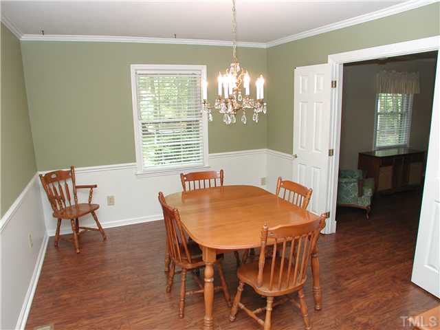 8416 Azalea Place Raleigh, NC 27613 - Photo 5 of 12 a view of a dining room with furniture window and wooden floor