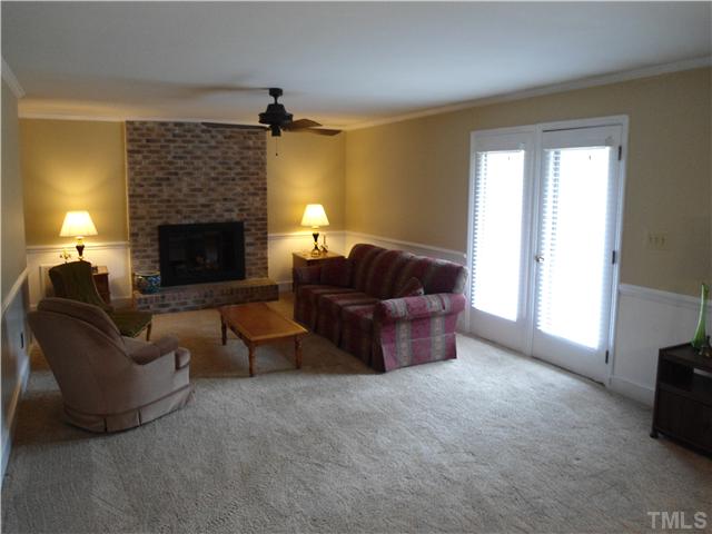 8416 Azalea Place Raleigh, NC 27613 - Photo 9 of 12 a living room with furniture and a fireplace