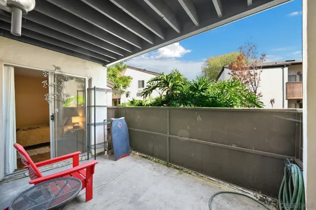 a backyard of a house with wooden floor and outdoor seating