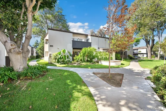 a view of a chair and table in backyard of the house