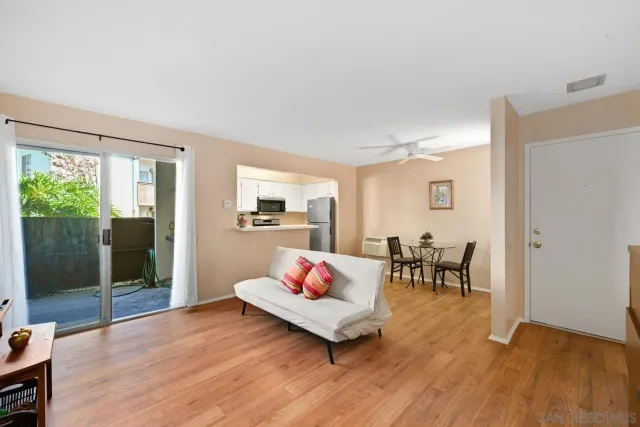a living room with furniture rug and dining table