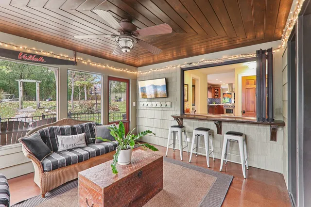 a dining hall with stainless steel appliances granite countertop a barbecue grill and a wooden floor