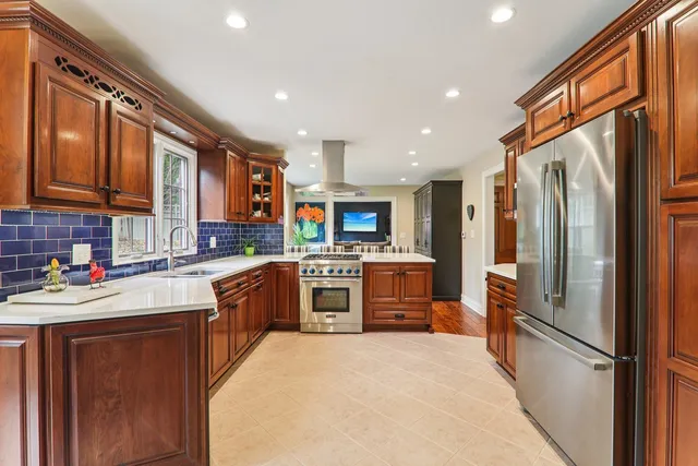 a kitchen with stainless steel appliances granite countertop a sink stove and cabinets