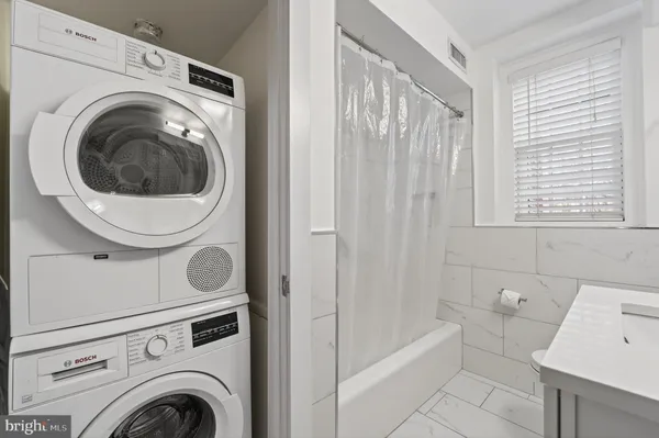 a bathroom with a shower and a sink