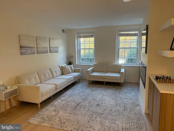 a view of a kitchen with furniture and wooden floor