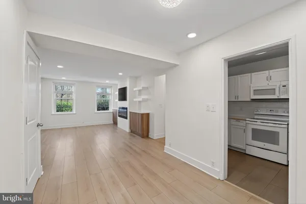 a kitchen with white cabinets and a sink