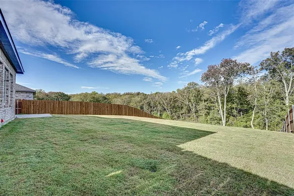 a view of grassy field with mountain
