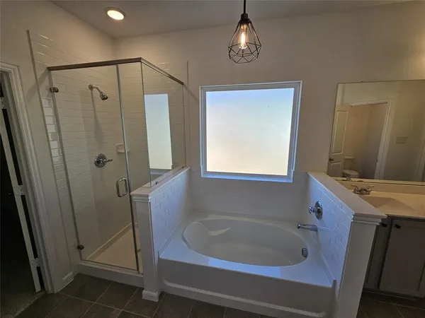 a bathroom with a sink a toilet a mirror and shower