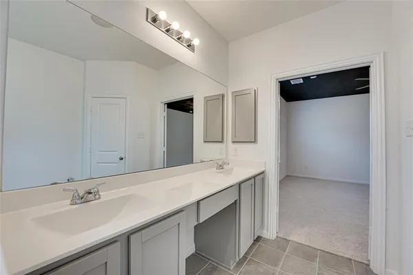 a bathroom with a sink double vanity and a mirror