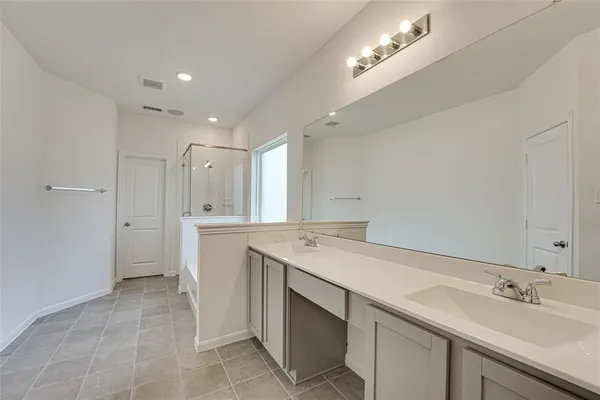 a spacious bathroom with a sink and a mirror