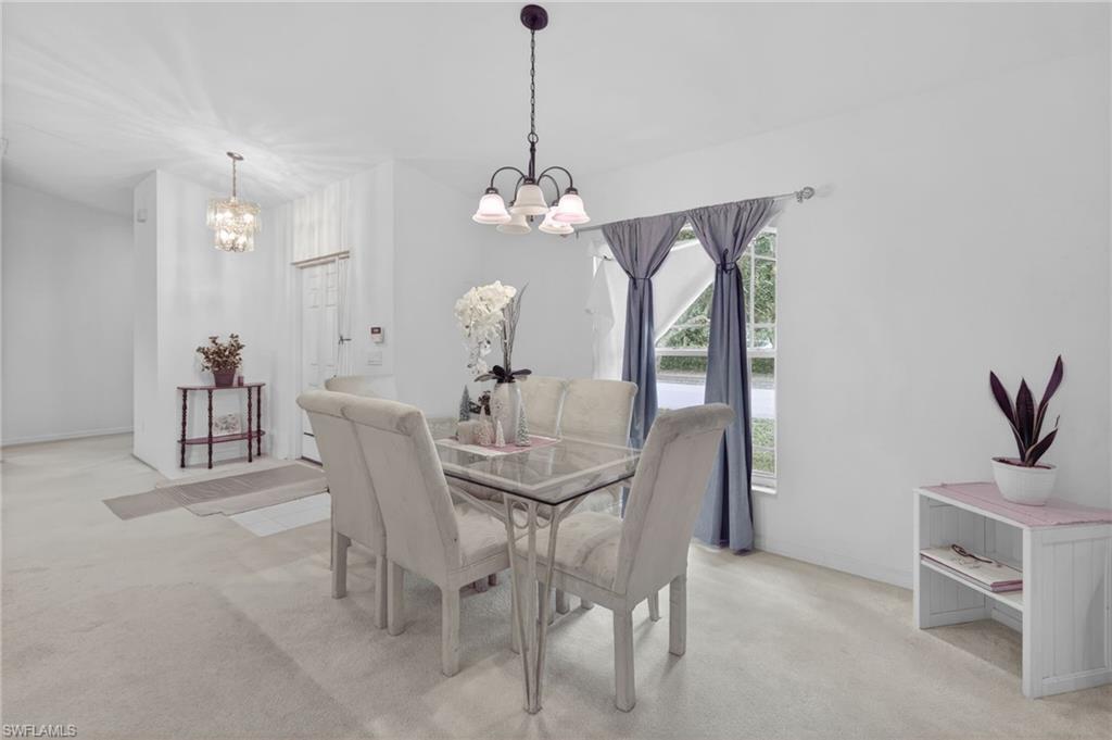 3920 10th Street North Naples, FL 34103 - Photo 15 of 47 Dining space featuring light colored carpet and baseboards