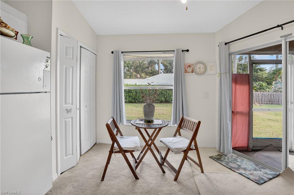 3920 10th Street North Naples, FL 34103 - Photo 21 of 47 Dining room featuring healthy amount of natural light and light colored carpet