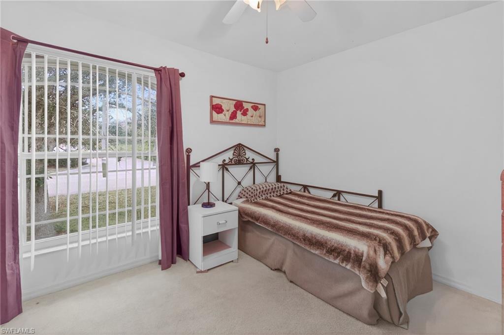 3920 10th Street North Naples, FL 34103 - Photo 23 of 47 Bedroom featuring light colored carpet and a ceiling fan
