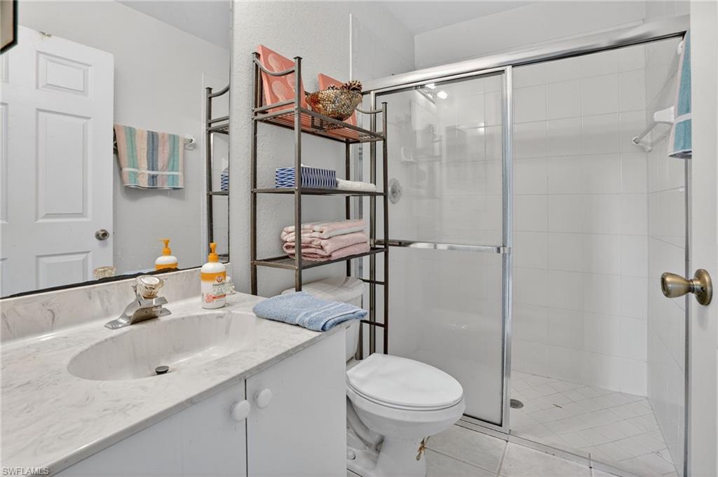3920 10th Street North Naples, FL 34103 - Photo 27 of 47 Full bathroom featuring vanity and a stall shower