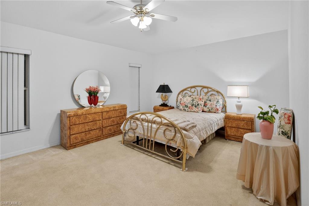 3920 10th Street North Naples, FL 34103 - Photo 30 of 47 Bedroom with carpet, ceiling fan, and a closet