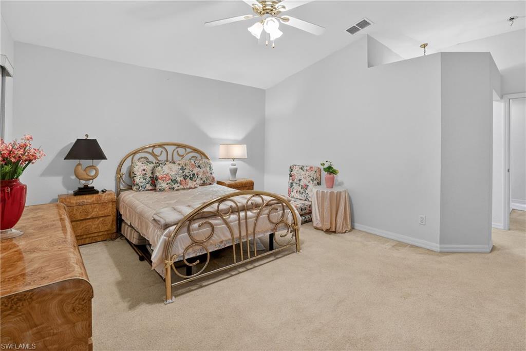 3920 10th Street North Naples, FL 34103 - Photo 32 of 47 Bedroom with light carpet, lofted ceiling, and ceiling fan