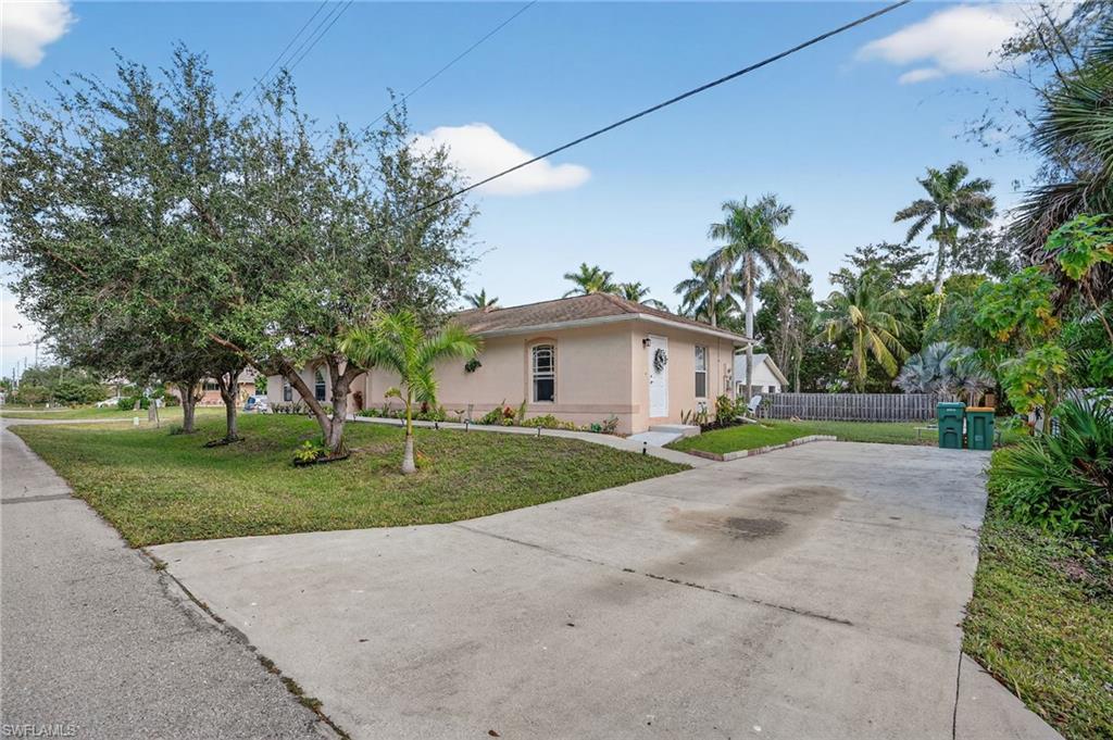 3920 10th Street North Naples, FL 34103 - Photo 6 of 47 Rear entrance and driveway.