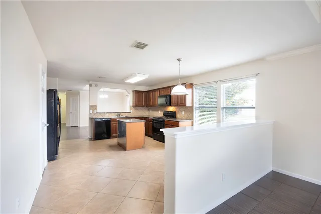 a kitchen with a refrigerator and a sink
