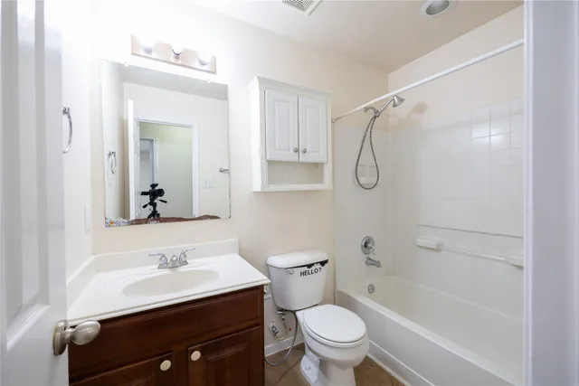a bathroom with a sink toilet vanity and shower