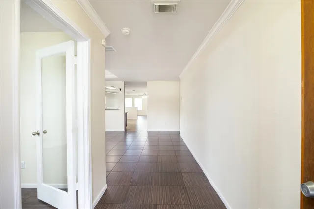 a view of a hallway with wooden floor
