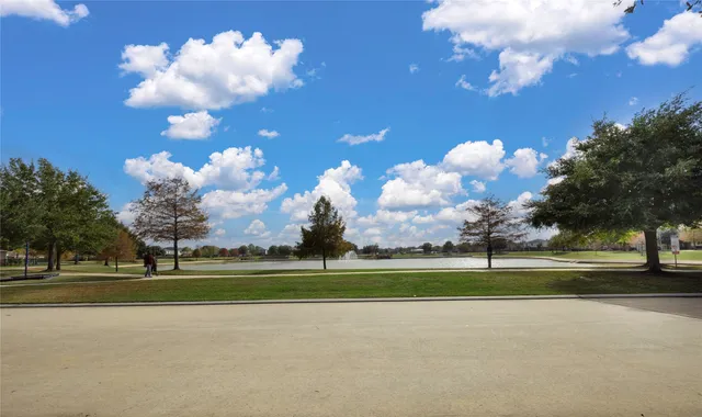 a view of a golf course with a large trees