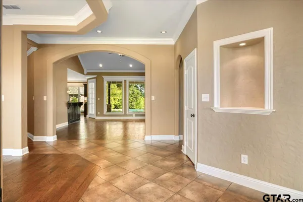 a view of a hallway with wooden floor and a living room