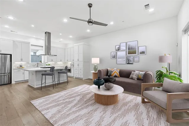 a living room with furniture and a wooden floor