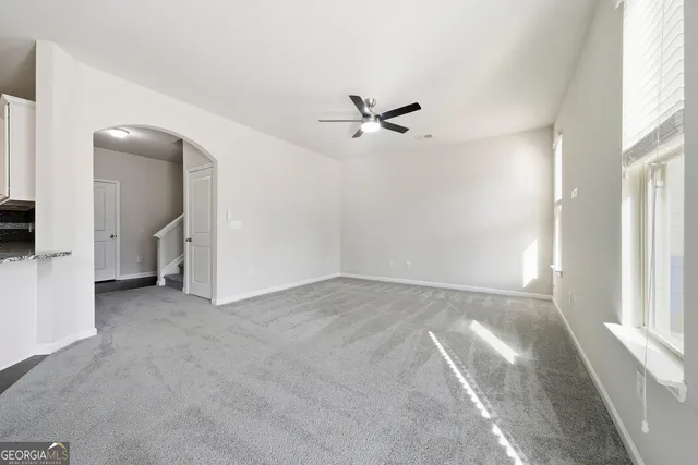 a view of a big room with closet and windows