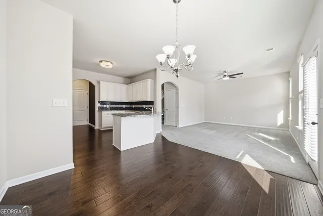 a view of a kitchen with a sink wooden floor and a kitchen space