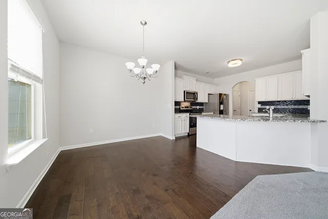 a view of kitchen with sink and refrigerator